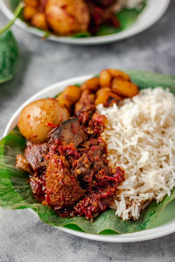 OFADA RICE PLATAIN BOILED EGG ASSORTED MEAT IN OFADA SAUCE ,PLANTAIN WITH ONE PROTEIN[CHICKEN OR FISH